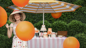Bristol Wellesley: Woman with orange balloons, umbrella and cakes