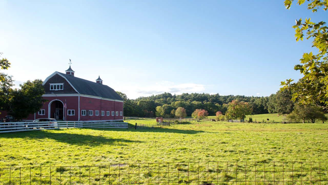 red barn and white fence on farm