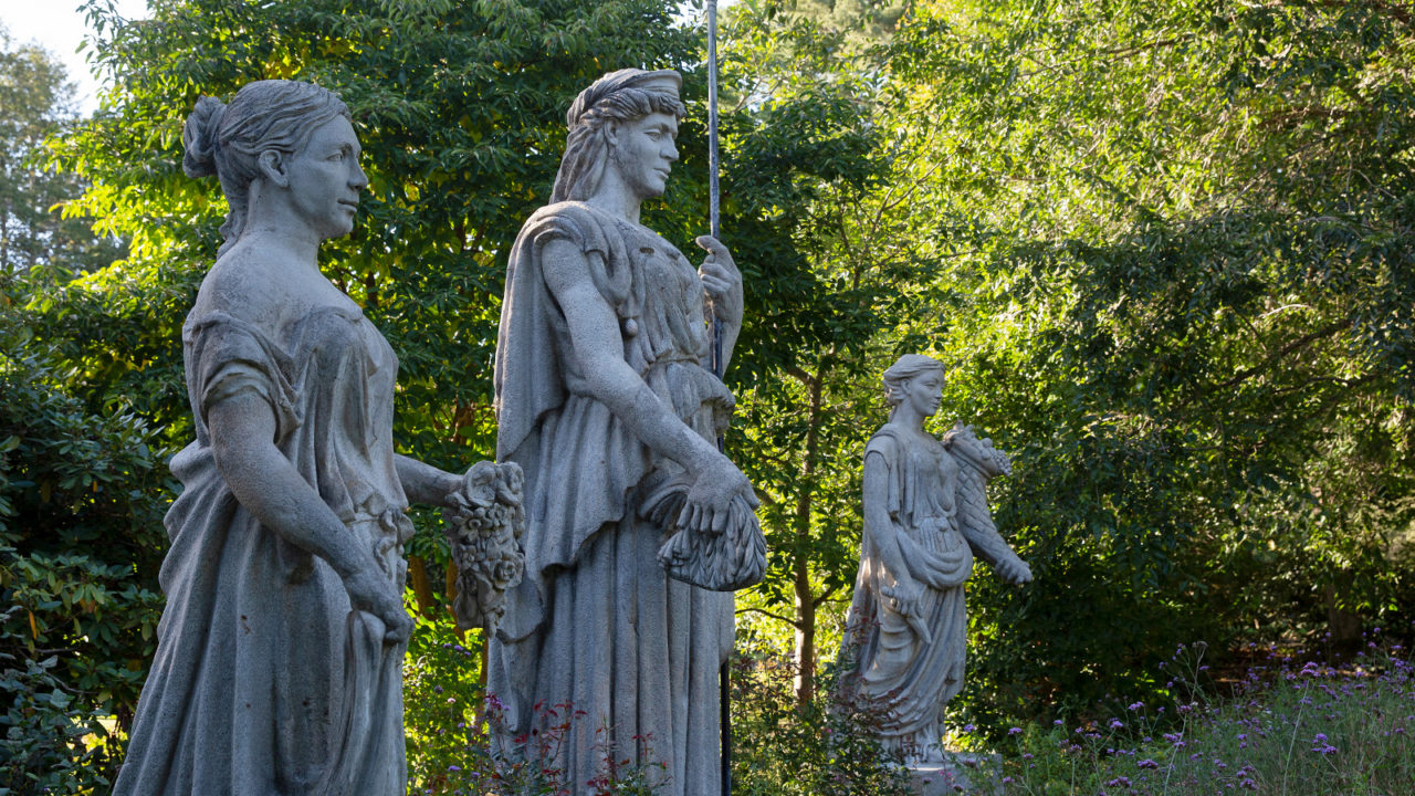 Statues with green trees in background