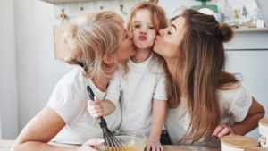 Mother, daughter, and grandmother baking in the kitchen