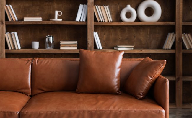 Leather sofa in front of dark wood shelves at The Bristol Wellesley.